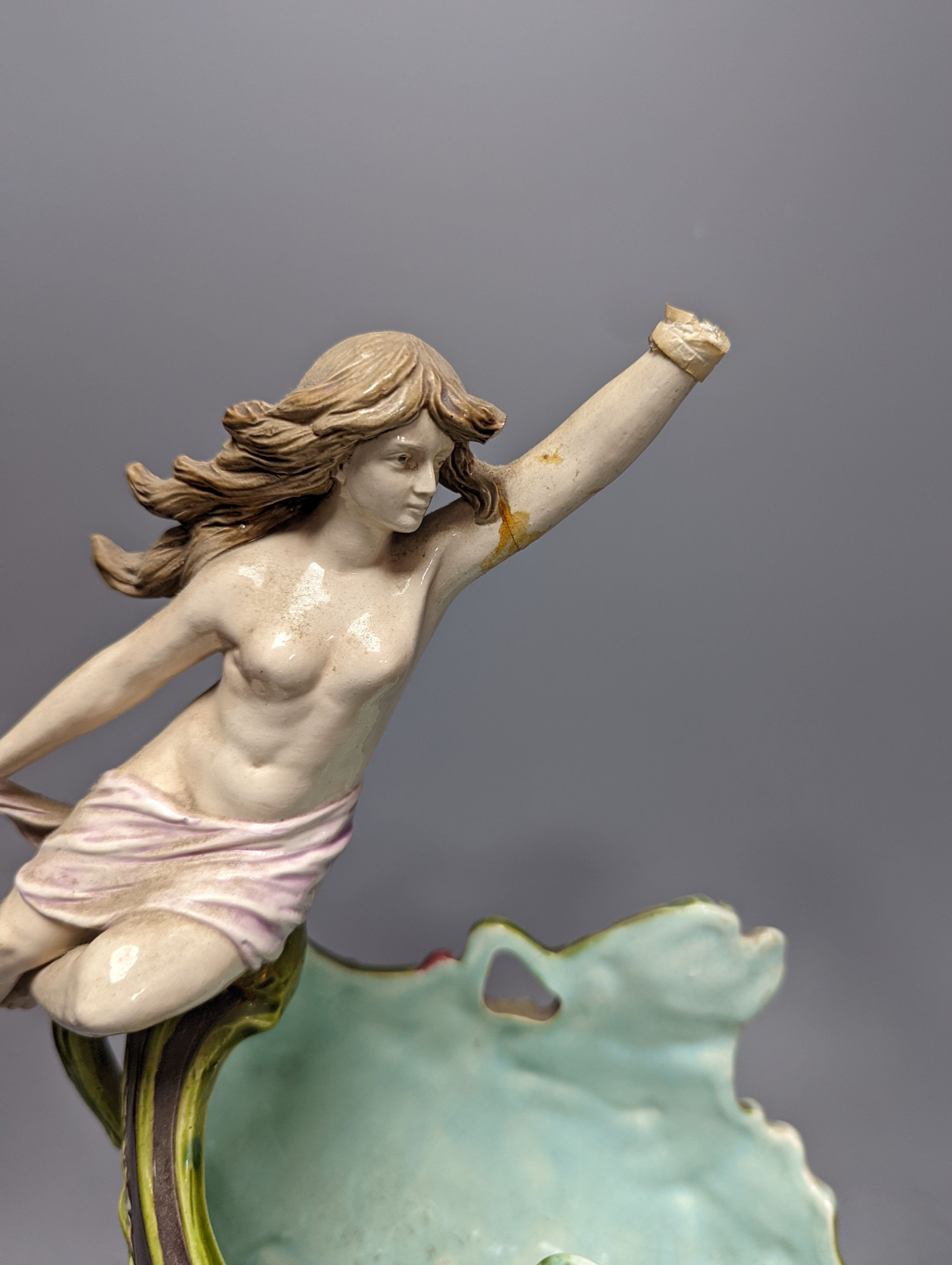 An Austrian or German majolica Triton and nymph figural centrepiece bowl, 39cm tall